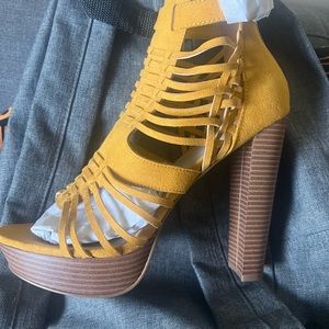 Black pair and a mustard pair of heels never worn
